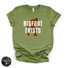 Bigfoot Exists Tee | Funny Cryptid Graphic T-Shirt (WHITE DESIGN)