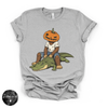 Pumpkin Head Bigfoot on a Crocodile Tee | Funny Cryptid Halloween Graphic T-Shirt