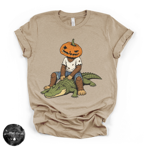 Pumpkin Head Bigfoot on a Crocodile Tee | Funny Cryptid Halloween Graphic T-Shirt