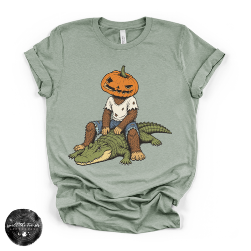 Pumpkin Head Bigfoot on a Crocodile Tee | Funny Cryptid Halloween Graphic T-Shirt